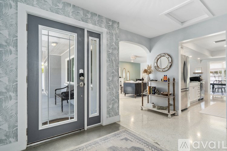 A modern kitchen with a large mirror on the wall.