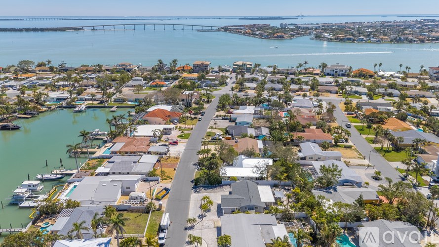 A bird's eye view of a residential area with a bridge in the background.