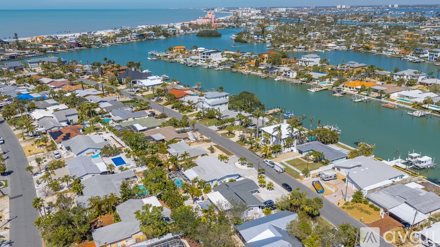 A bird's eye view of a residential area with houses and boats.