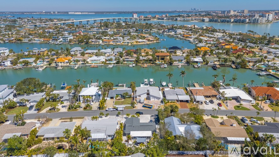 A bird's eye view of a residential area with houses and a body of water.