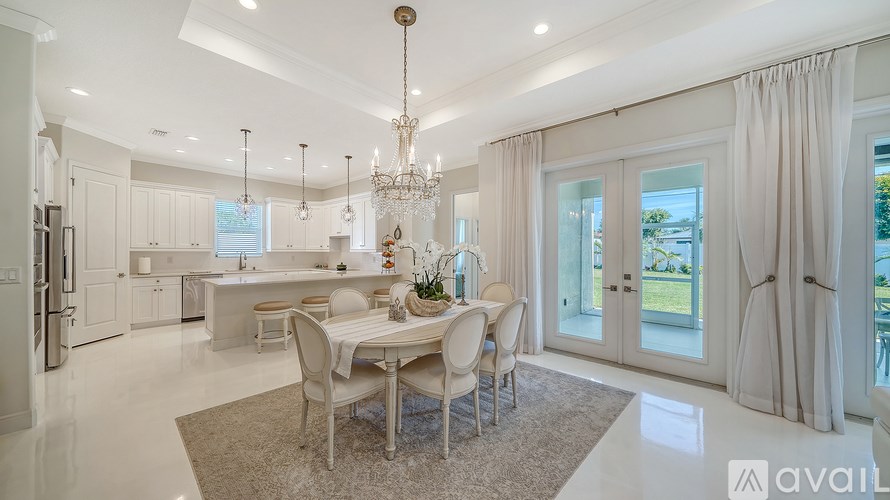 A modern dining room with a large table and chairs.