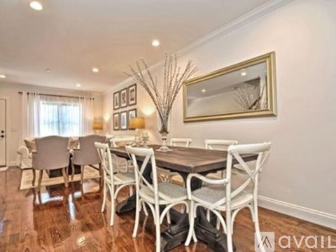 A dining room with a table set for four.
