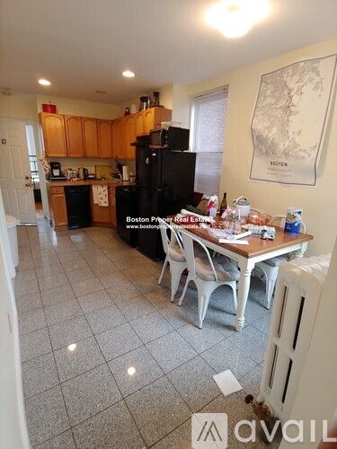 A kitchen with a table and chairs in the middle of the room.
