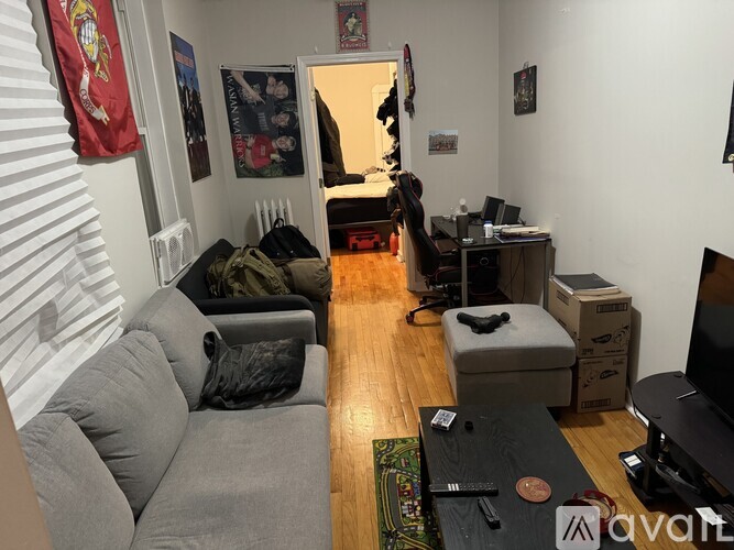 A living room with a grey couch and a television.