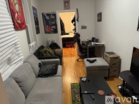 A living room with a grey couch and a television.