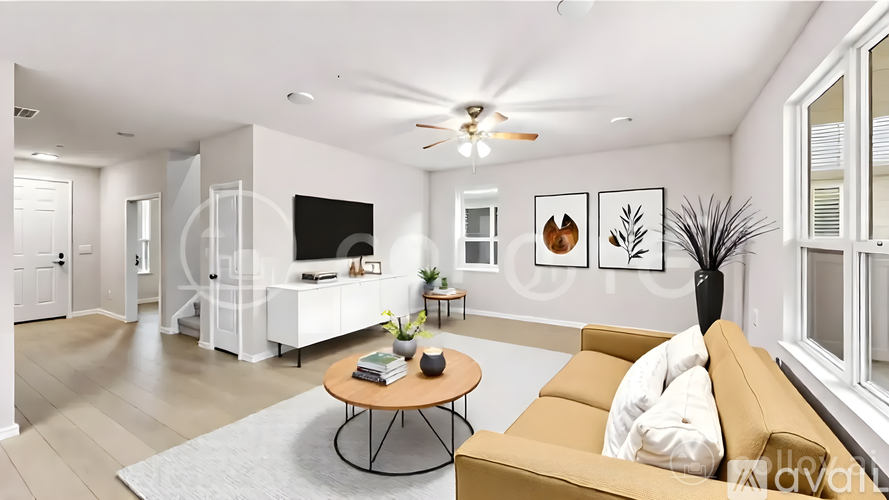A living room with a brown sofa and a coffee table.