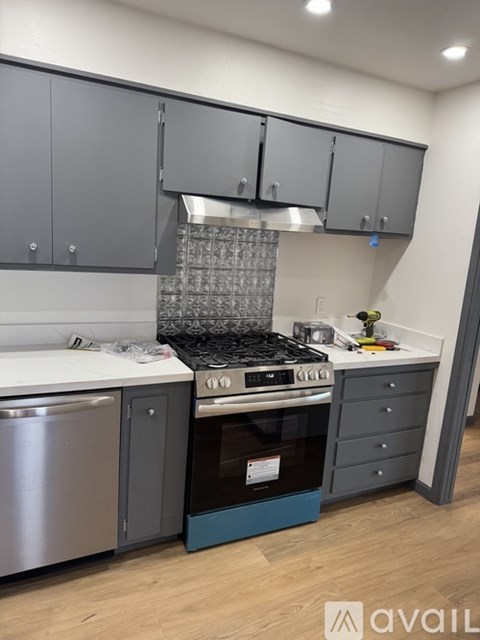 A kitchen with a stove top oven and a dishwasher.