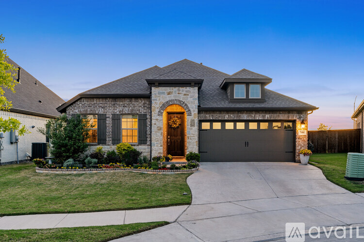 A house with a front yard and a driveway.