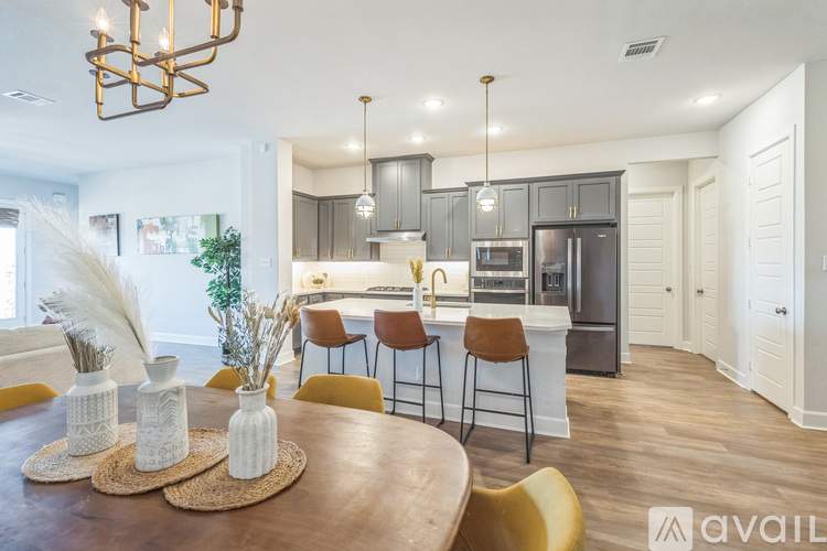 A modern kitchen with a dining table set for four.