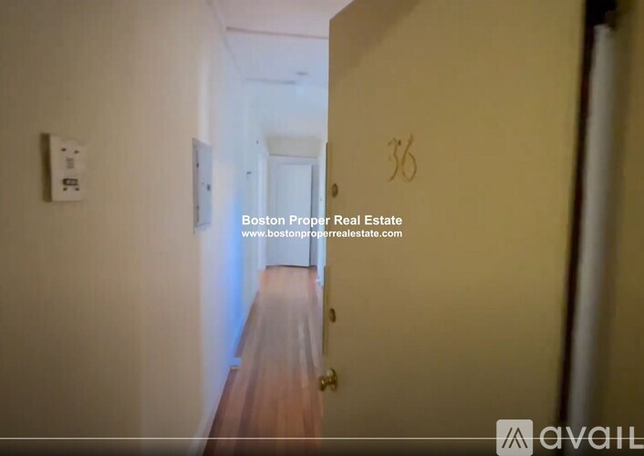A hallway with a door numbered 36.
