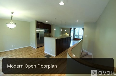 A modern open floor plan with a kitchen, dining area, and living room.