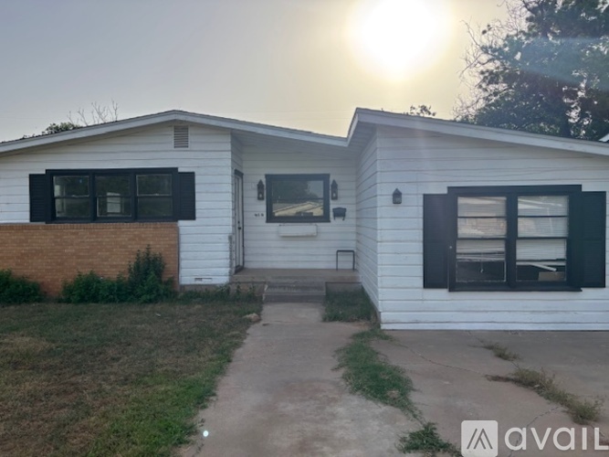 A house with a white exterior and black shutters is available for rent.