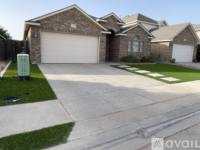 A house with a garage and a driveway in front.