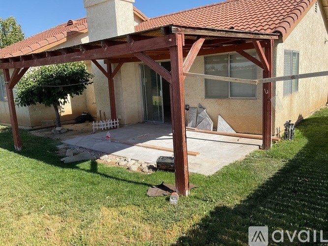 A house with a covered patio and a pool table.