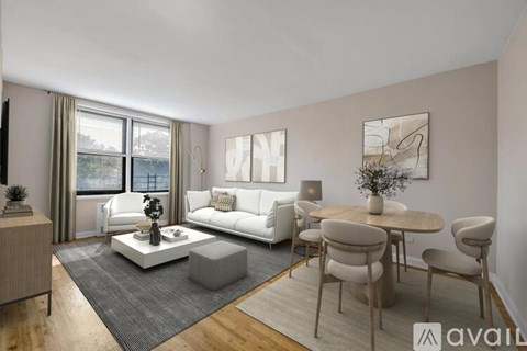 A living room with a white couch, a grey coffee table, and a dining table with chairs.