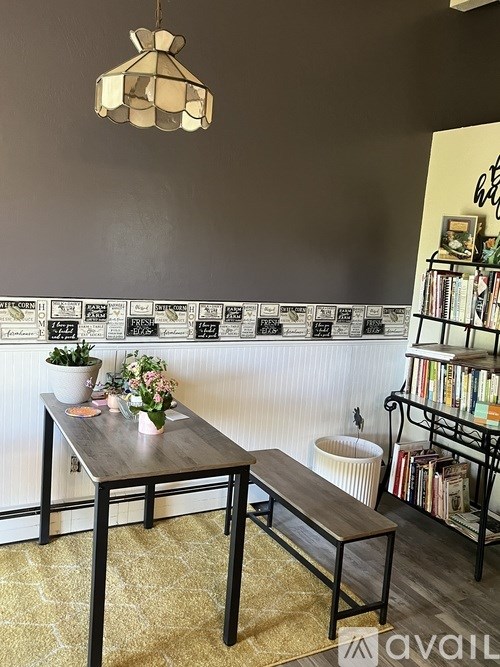 A dining room with a table and chairs.