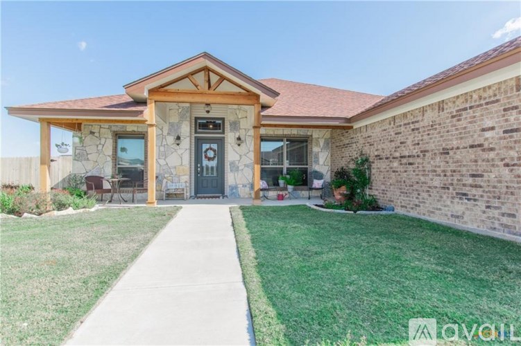 A house with a front yard and a walkway leading to the front door.
