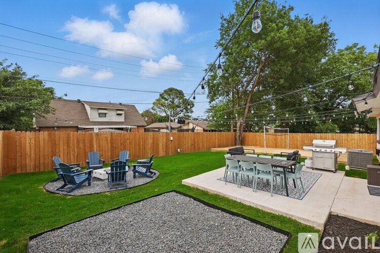 A backyard with a table and chairs set up for outdoor dining.