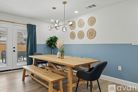 A dining room with a wooden table and chairs.