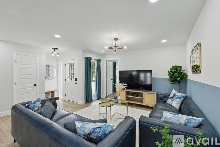 A living room with a grey couch and a television.
