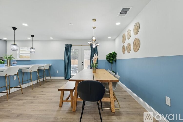 A dining room with a wooden table and chairs.