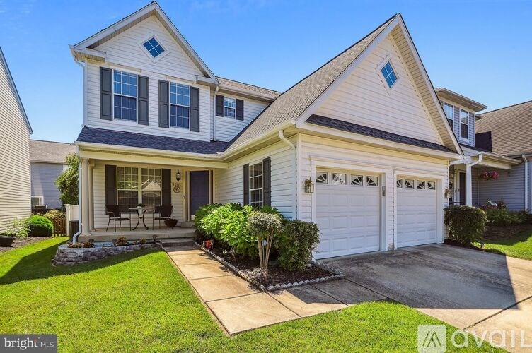 A two-story house with a garage and a front porch.