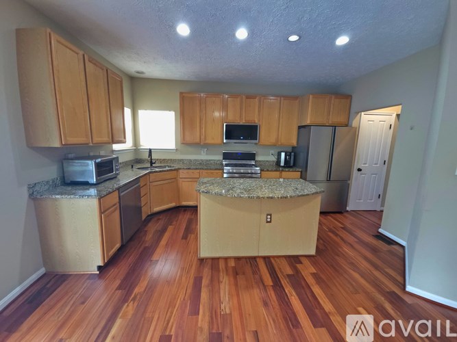A kitchen with wooden cabinets and a central island.