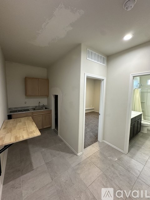 A kitchen with a wooden table and a sink.