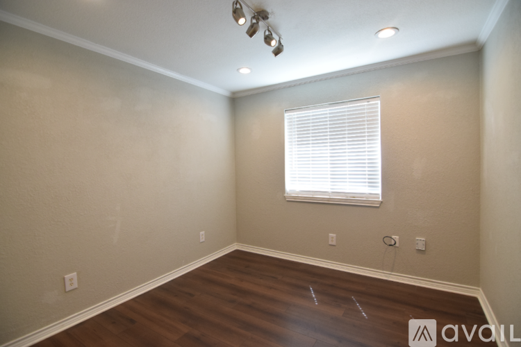 A bedroom with a large bed and a ceiling fan.