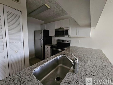 A kitchen with granite countertops and stainless steel appliances.