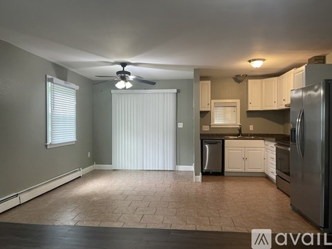 A kitchen with a refrigerator, microwave, and oven.