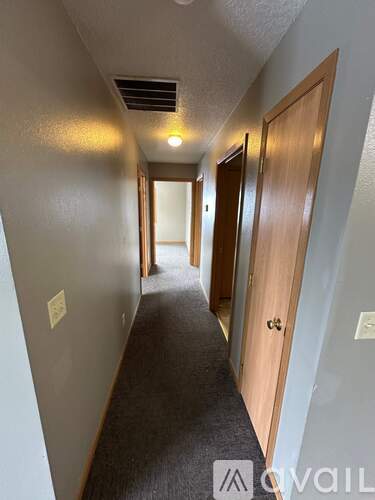 A long hallway with doors on both sides.