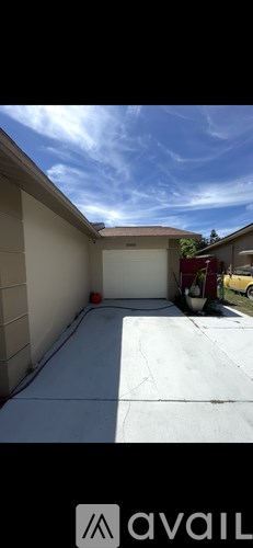 A car is parked in a driveway next to a house.