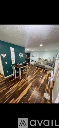 A room with wooden flooring and a white ceiling.