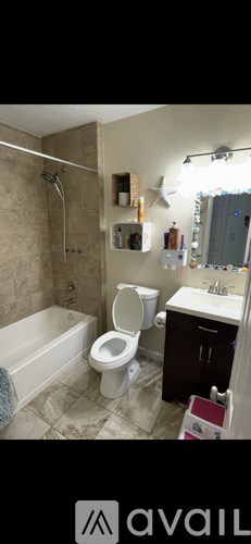 A bathroom with a toilet, sink, and bathtub.