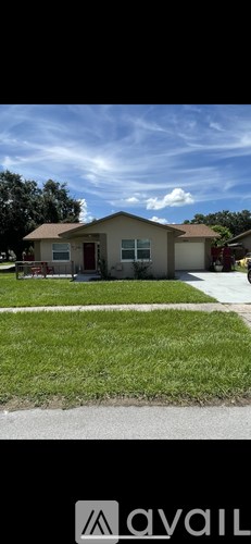 A house with a red door and a white garage door is shown.