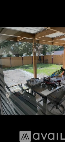 A table with a toy car on it is in the foreground of an outdoor scene.
