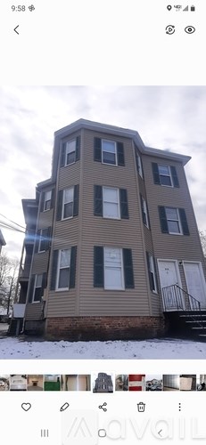 A building with a grey facade and black shutters.