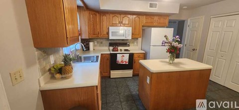 A kitchen with wooden cabinets and a white countertop.