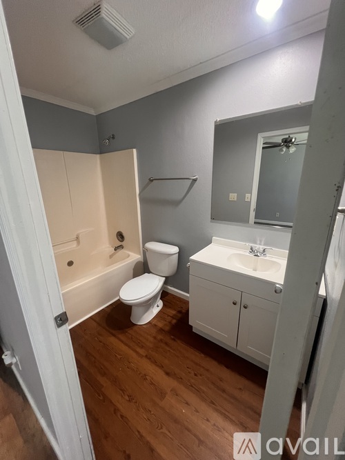 A bathroom with a toilet, sink, and bathtub.