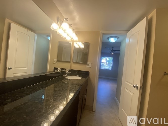 A bathroom with a vanity and a mirror.
