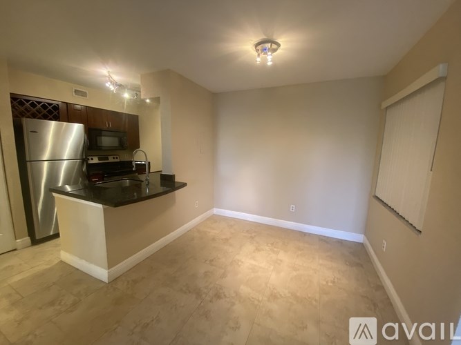 A kitchen area with a refrigerator, microwave, and oven.