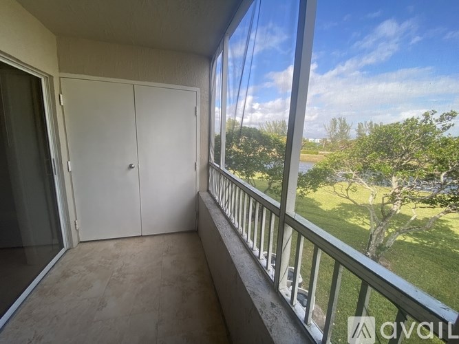 A balcony with a white door and a glass railing.
