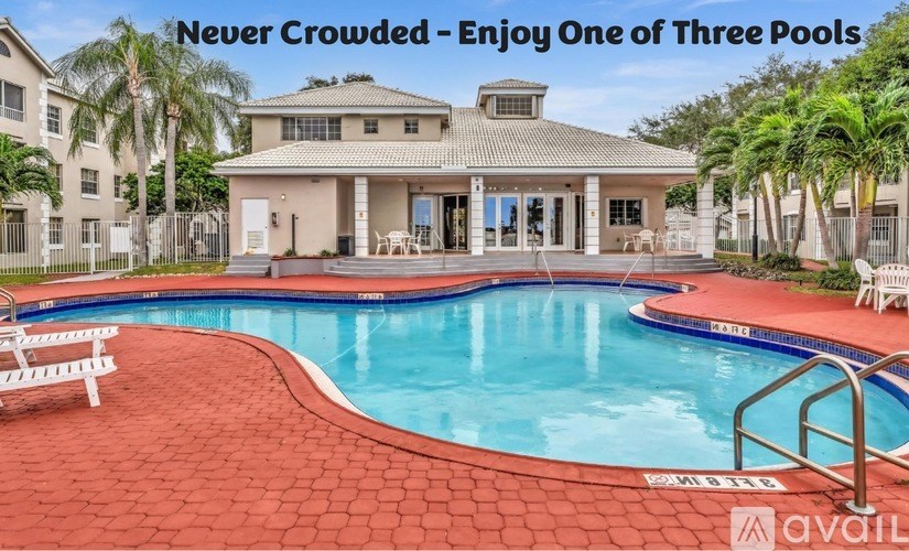 A large house with a pool and a sign that says "Never Crowded - Enjoy One of Three Pools".
