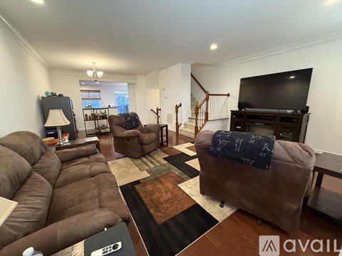 A living room with a brown sofa and a television.