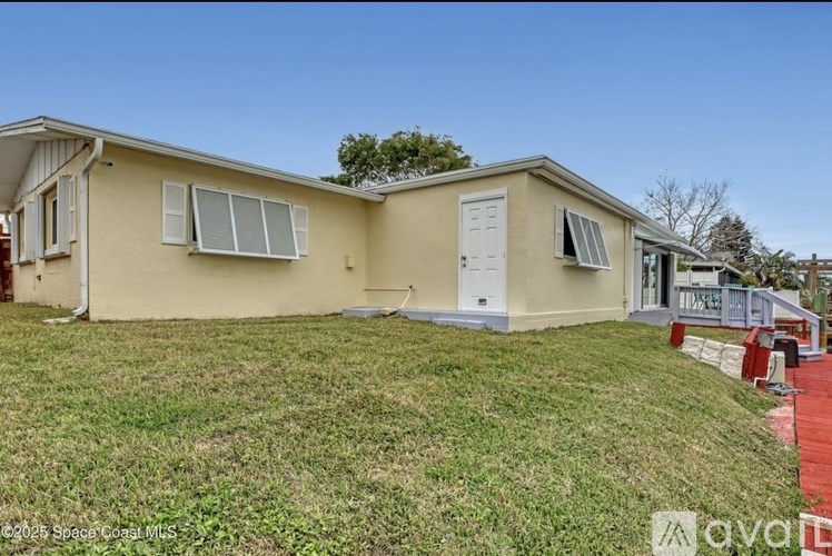 A small house with a red fence in front.