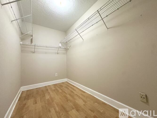 A room with wooden flooring and a ceiling fan.