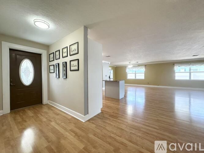 A room with wooden flooring and a ceiling fan.