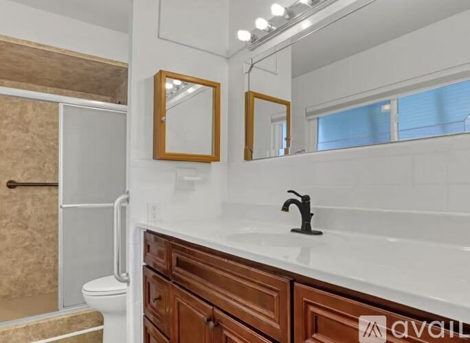 Empty room with wooden floor and two windows.