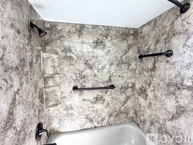 A bathroom with a sink, mirror, and toilet.